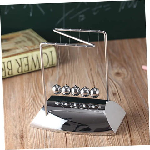 Z Shape Newton Cradle Pendulum Desk Toy For Home Office Decor with silver finish and five-ball design on a wooden desk