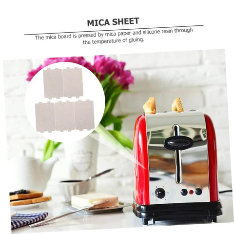 Mica sheets for microwave oven next to red toaster in kitchen setting.