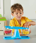 Child using Blue Nestable Double Bucket Balance Scale For Liquids And Solids, Clear Weighing Balance For Classroom, Easy To Assemble