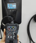 EVSE Charger Tester For Electric Vehicle Charging Stations Plug And Play Simulation Adapter connected to wallbox display.