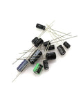 A scattered arrangement of capacitors from the 120 Piece Aluminum Electrolytic Capacitor Kit With 12 Common Values From 0.22uF To 470uF For DIY Electronics Projects A Handy Kit For Hobbyists And Pros Versatile Assortment For Circuits And Repairs.