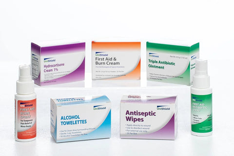 Seven UniShield first-aid products: creams, sprays, wipes, and alcohol towelettes.