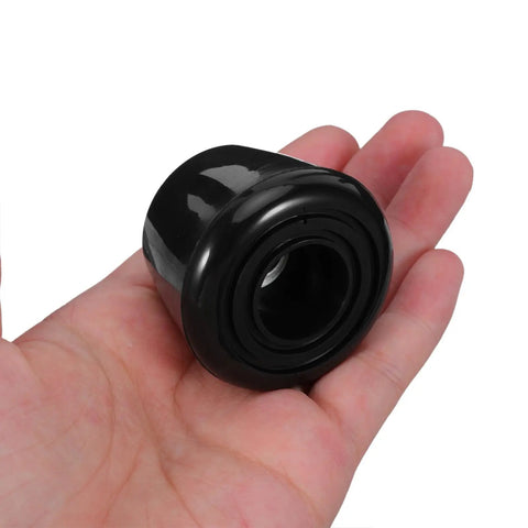 Hand holding black roller skate toe stops for quad skates, shock absorption, screws included, sleek modern design