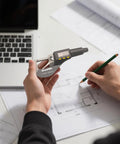 Person using Pro Grade Digital Micrometer Measuring Tool For Precision Inch And Metric Thickness With 0.00005 In 0.001 Mm Accuracy