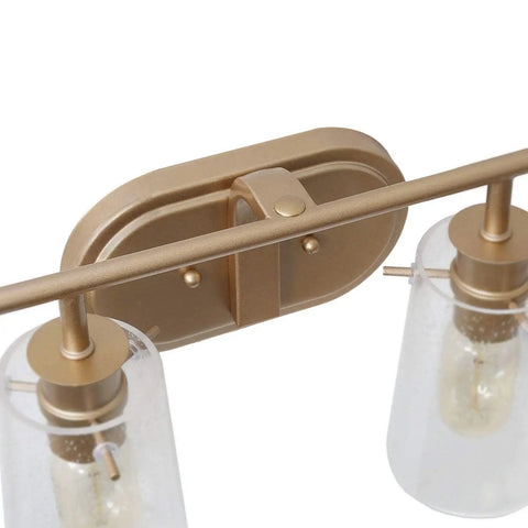 Gold Vanity Light Over Mirror with antique brass finish and clear bubbled glass shades, close-up of back plate detail.