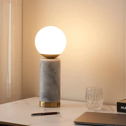 Aspen LED Table Lamp With USB Port For Bedside Or Desk Ambient Lighting And Marble Finish Globe Shade on white tabletop