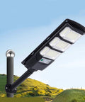 JUDYSSY 400W Super Bright Led Beads Commercial Solar Flood Lights mounted on pole, illuminating outdoor area with wide angle light.