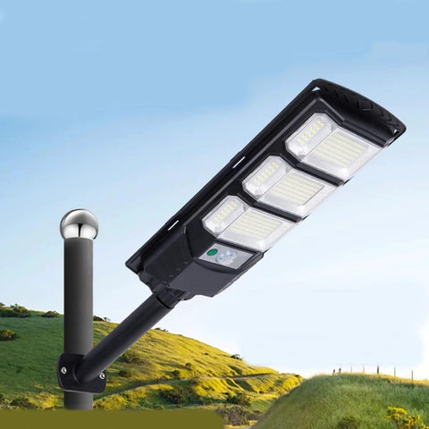 JUDYSSY 400W Super Bright Led Beads Commercial Solar Flood Lights mounted on pole, illuminating outdoor area with wide angle light.
