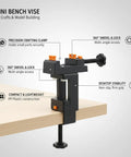 Mini Desktop Vise For Crafts And Jewelry Making, Tiny Bench Clamp For Model Building, Durable Plastic Workholding Tool With Secure Grip On Black Color on a wooden desk.
