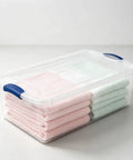 Heavy Duty 32 Quart Medium Clear Plastic Latching Storage Bin With Snap Tight Locking Lid Spill Resistant Container holding neatly folded towels.