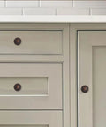 Oil Rubbed Bronze Cabinet Knobs With Backplates, 2.5 Inch, 2 Pack, on a beige kitchen cabinet and drawer