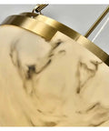 Close-up view of Top Tier Black And Gold Marble Pendant Light Fixture For Upscale Kitchens And Banquet Halls with gold accents.