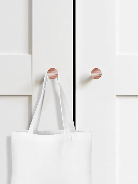 2-Pack Real Solid Beech Wood Cabinet Knobs with Kickin Red Brushstroke Painting and Misty Foggy Grey Details displayed on white cabinet with tote bag.
