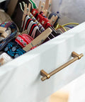 Drawer with Six Pack 5 Inch Center To Center Knurled Antique Brass Cabinet Bar Handle and colorful ribbons inside
