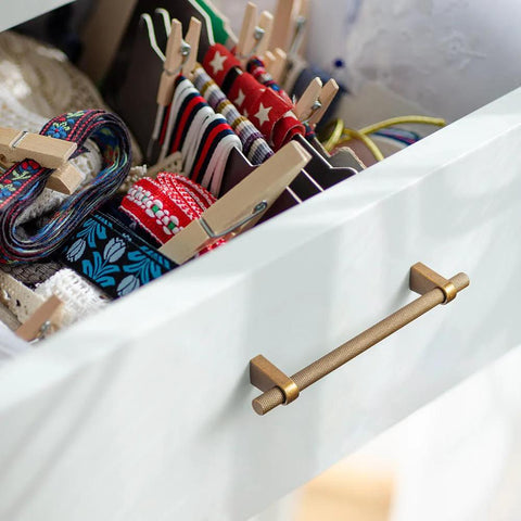 Drawer with Six Pack 5 Inch Center To Center Knurled Antique Brass Cabinet Bar Handle and colorful ribbons inside
