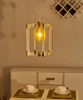 Gold Pendant Light Fixture With Brushed Brass Finish, 1 Light Modern Linear Chandelier illuminating a dining setting.