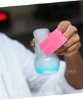 Image of Badass 100 Pc Antistatic Latex Finger Sleeves used to grip a flask in a lab setting, providing sweat-free cushioning.