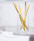 Premium Ballpoint Pen Set Of 6 In Glossy White Gift Box With Gold And Black Ink For Women And Men displayed in a glass holder