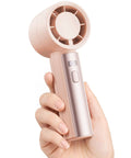 Woman holding Compact Handheld Personal Fan With Turbo Wind On The Go USB Rechargeable Mini Cooler For Travel And Outdoors
