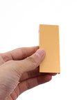 Hand holding 80mm gold Four Pack Invisible Drawer Pulls 80mm Gold Slick Edge Finger Pulls For Cabinets And Drawers Modern Kitchen Hardware