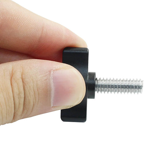 Close-up of 4 Pack Stainless Steel Thumb Screws With Black Aluminum Knobs 1/4-20 x 3/4 Inch Tee Wing Hardware held in hand.