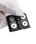 Close-up of black pivot hinge from 10 Series 1010 Hinge And Door Handle Kit For 1 By 1 Inch Aluminum Profiles, held by gloved hand