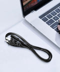 2 Prong 5Ft Power Cord For PlayStation And Xbox Consoles, Gamer Ready Replacement Cable, Compatible With PS5 PS4 PS4 Slim PS3 Slim Super Slim, Xbox Series S X, Xbox One S X, 18 AWG Figure 8 IEC320 C7 black cord coiled beside laptop