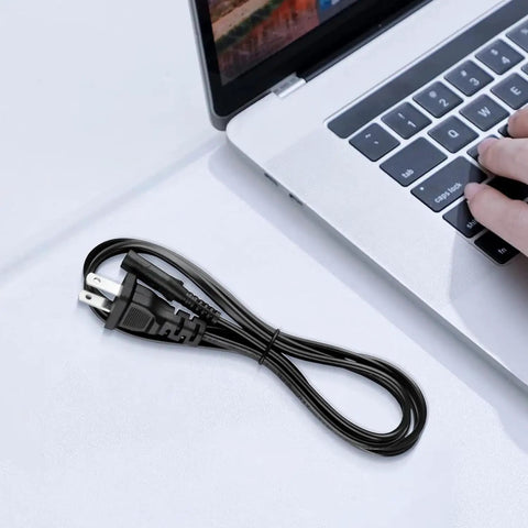 2 Prong 5Ft Power Cord For PlayStation And Xbox Consoles, Gamer Ready Replacement Cable, Compatible With PS5 PS4 PS4 Slim PS3 Slim Super Slim, Xbox Series S X, Xbox One S X, 18 AWG Figure 8 IEC320 C7 black cord coiled beside laptop