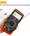 Person holding a 6000-Count True RMS Digital Multimeter With Auto And Manual Ranging, displaying line test function.