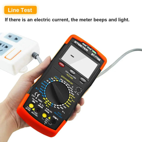 Person holding a 6000-Count True RMS Digital Multimeter With Auto And Manual Ranging, displaying line test function.