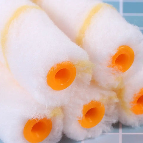 30 PCS Mini Paint Roller Sleeve Refills, High Density Foam Rollers For Wall Painting, close-up on round foam sleeves with orange ends.