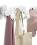Slick Scandinavian Wall Mounted Coat Hooks Knockout Resin Organizer with white hat, scarf, and tote on display.