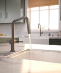 hansgrohe Talis N Pull Down Kitchen Faucet, Modern, Magnetic Hand Sprayer, 1-Handle, 1.75 GPM, Brushed Black Chrome, 72867341 with water flow in modern kitchen.