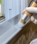 Using Super Slick Three Piece Chalk Wax Paint Brush Set For Furniture Makeovers on window trim for smooth coating.