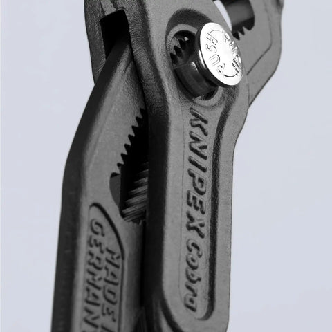 Close-up of 12 Inch Water Pump Pliers with Quick Button Adjustment on the Workpiece Fine Jaw Tuning for Different Sized Pieces