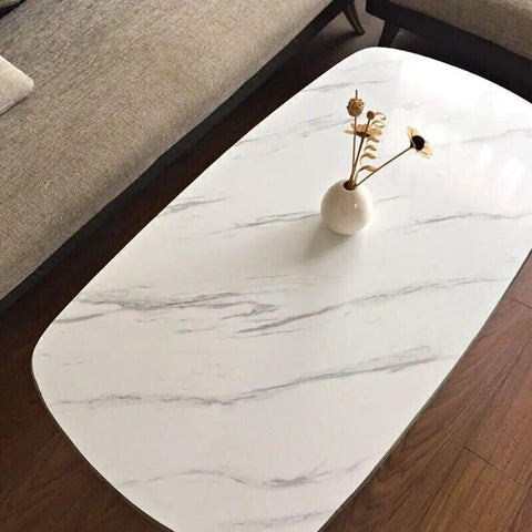 Tabletop with White Marble Peel And Stick Contact Paper 24 Inch Wide By 200 Inch Long Waterproof Vinyl Wrap For Kitchen Countertops Cabinets And Furniture Easy DIY Quick Install Glossy Marble Finish in a living room setting.