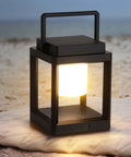 Outdoor Solar Lantern Table Lamp with handle on beach at dusk