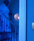 Carbon Monoxide Detector With Ten Year Battery Digital Display Three LEDs Replacement Indicator Peak Level Memory Two Pack For Easy Home Safety No Wiring Needed And It Alerts On Power Outage With An 85 Decibel Alarm mounted on wall near stairs.