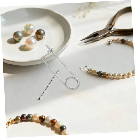 20pcs Stainless Steel Brooch Shape Cotter Pins Quick Lock Spring Safety Fasteners on a crafting table with beads.