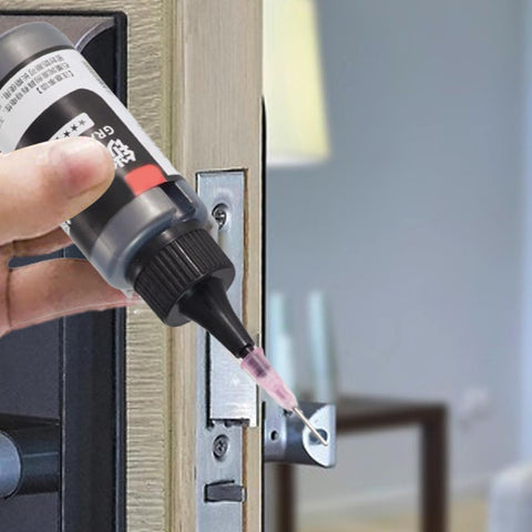 Natural Graphite Powder Lubricant 50ml Dry Lube In A Handy Needle Design Tube being applied to a door lock cylinder