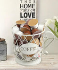 White Wire K Cup Storage Organizer For 35 Pods placed on kitchen counter with coffee pods inside, next to decor.