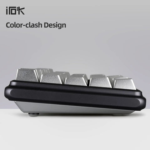 Compact 60 Percent Wired Mechanical Keyboard With Full Metal Chassis And Hot Swappable Red Switches Providing Customizable Rgb Lighting For Pc Gamers Wanting A Straight Durable Rig Upgrade That Is Totally Dialed In, side view showcasing silver keys.