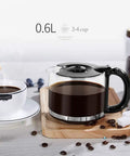 Hassle Free Mini Coffee Maker With Built In Bean Grinder And Glass Carafe, Solid Six Cup Drip Brewer featuring a glass carafe with brewed coffee.