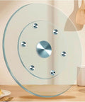 Round Tempered Glass Lazy Susan Turntable Smooth Operator with aluminum spin shaft on a wooden dining table.