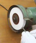 Heavy Duty Seven Inch Bench Grinding Wheel 100 Grit Chrome Corundum Pro Grade Metal Shaping Accessory in use on drill bit.