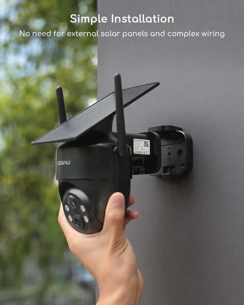 Hand installing Solar Powered Wireless Outdoor Security Camera With 2K 360 Degree View Color Night Vision on wall