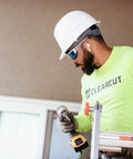 Worker on ladder wearing Khor G2 Polarized Wraparound Safety Glasses With Vapor Shield Go To Anti Fog Anti Scratch UV 400 Protection.
