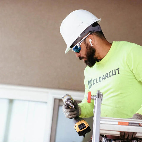Worker on ladder wearing Khor G2 Polarized Wraparound Safety Glasses With Vapor Shield Go To Anti Fog Anti Scratch UV 400 Protection.