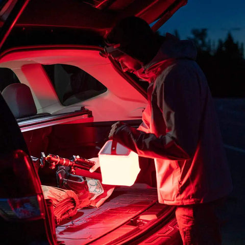 Person using 2 In 1 Solar Camping Lantern And Phone Charger With 300 Lumens Of Bright LED Light, Red Night Mode, Turbo Boost outdoors