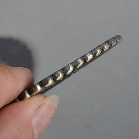 Close-up of the edge of a Two Piece Brass Seppa Spacer Set for Japanese Samurai swords replacement tsuba tightening fitting.